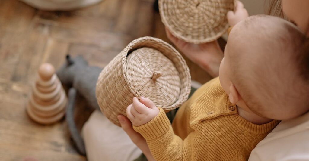 A mother and baby bond while playing with wooden and woven toys on a wooden floor, creating a warm family moment.